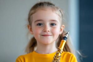 Young girl smiles holding a golden musical instrument in a bright indoor space during a music session photo