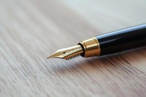 Close up of a fountain pen resting on a wooden surface, highlighting its intricate nib design and craftsmanship photo