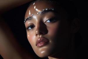 Stunning close-up of a model with glamorous makeup in dramatic lighting during a fashion shoot photo