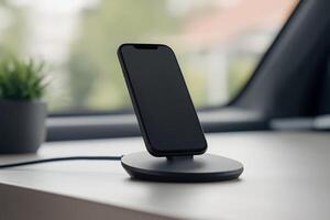 Charging dock with smartphone placed on a modern desk in a bright workspace photo