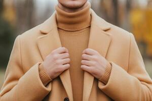 Man wearing stylish autumn fashion in a park during a sunny day photo