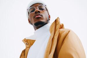 A young man dressed in a warm, stylish jacket and white turtleneck shows off his confident look photo