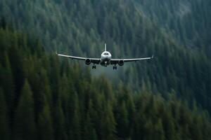 Airplane approaches landing in mountainous region surrounded by dense evergreen forests during daylight photo