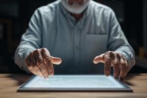 Elderly man interacts with touchscreen device in a dimly lit room while exploring digital content at night photo