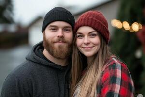 Cozy couple enjoying a chilly outdoor moment while wearing winter attire in a festive setting photo