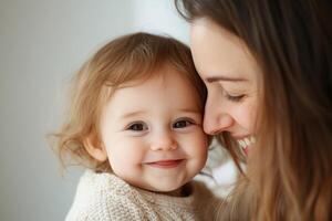 Smiling mother and baby share a joyful moment indoors during a sunny afternoon photo