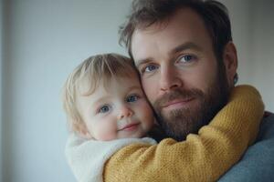 Father embraces child with a warm smile in a cozy indoor setting during a tender moment of connection photo
