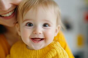 Happy baby smiling while being held by parent indoors with soft lighting and warm colors photo