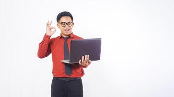 Asian Male Office Worker Business Man Showing Okay Sign with Finger While Holding Laptop Computer on White Background photo