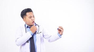 Shocked Asian Male Doctor Looking at Temperature in Thermometer on White Background photo