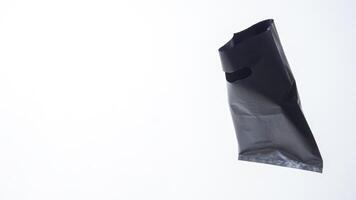 Open Blank Black Plastic Bag on White Background photo