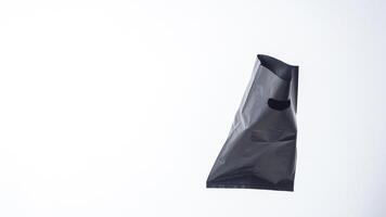 Open Black Plastic Bag with Copy Space on White Background photo
