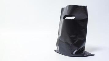 Open Black Plastic Bag with Handle on White Background photo