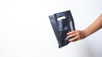 Man Hand Shows Black Blank Plastic Bag Mock Up with Handle on White Background photo