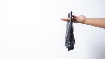 Man Hand with Black Plastic Bag on White Background photo