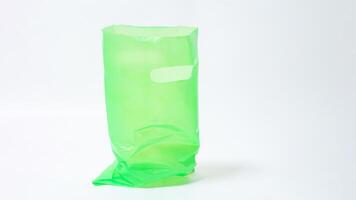 Open Green Plastic Bag with Handle on White Background photo