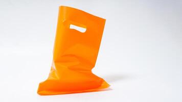 Used Open Orange Plastic Bag Mock Up with Handle on White Background photo