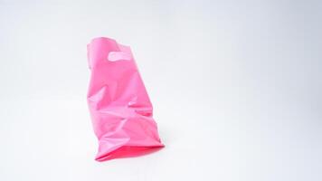 Open Used Pink Plastic Bag on White Background photo