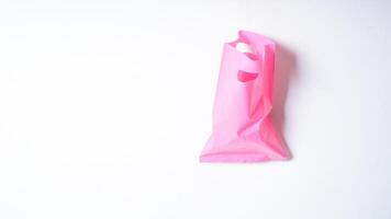 Open Pink Plastic Bag on White Background photo