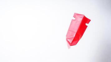 Side View of Open Red Pink Plastic Bag on White Background photo