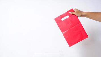 Hand Holding Red Pink Plastic Bag Mock Up on White Background photo