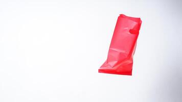 Open Red Pink Plastic Bag on White Background photo