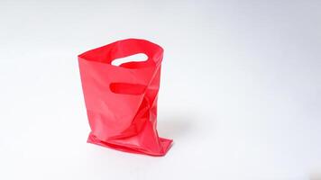 Empty Open Red Pink Plastic Bag on White Background photo