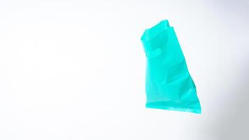 Open Turquoise Plastic Bag on White Background photo