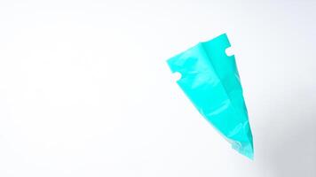 Side View of Open Turquoise Plastic Bag with Handle on White Background photo