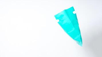 Side View of Open Turquoise Plastic Bag on White Background photo