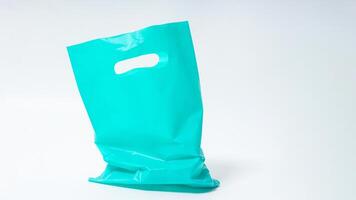 Empty Open Turquoise Plastic Bag Mock Up with Handle on White Background photo
