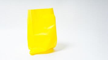 Empty Open Yellow Plastic Bag on White Background photo