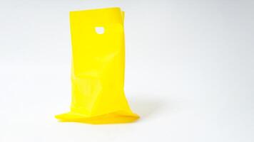 Empty Open Yellow Plastic Bag Mock Up with Handle on White Background photo