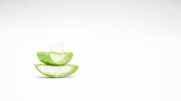 Heap of Aloe Vera Slices with Cube Gel on White Background photo