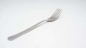 Modern stainless steel fork isolated on white background photo