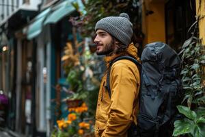 A man with a backpack standing in the street photo