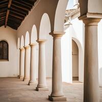 A row of white pillars in a courtyard photo