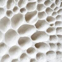 A close up of a wall made of white clay photo