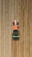 Top view of tractor sowing grain in the farm field. video
