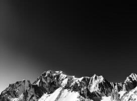 Punta Helbronner dominating the skyline of Courmayeur in black and white photo