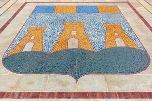 Mosaic in the pavement of the coat of arms of the city of Ostuni in Puglia, Italy. photo