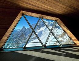 Mont Blanc massif seen from modern wooden structure with large windows in Courmayeur photo