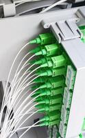 Fiber optic cables connecting to a server in a data center photo