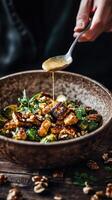 A sophisticated warm salad featuring perfectly seared golden tempeh slices and roasted Brussels sprouts with a light, caramelized glaze, dressed in a smooth, velvety nut-based sauce. photo