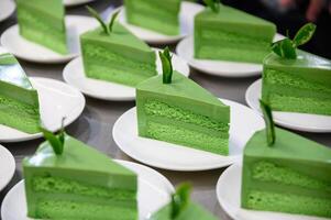 Green tea matcha cake slices with leaf on plate photo
