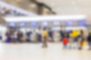 Blurred scene of passengers walk in to check-in counter on domestic airline in the airport photo