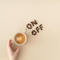 Cup of coffee with coffee beans switch on off composition on beige background. Morning wake up coffee break concept. Flat lay style. Coffee aesthetic. Top view. photo