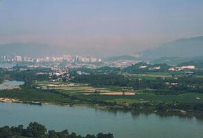 An aerial view of the skyline of Chiang Saen, Thailand with mountains in the background and the river that separates the two countries. photo