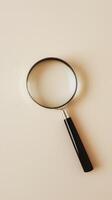 Magnifying glass on beige background photo