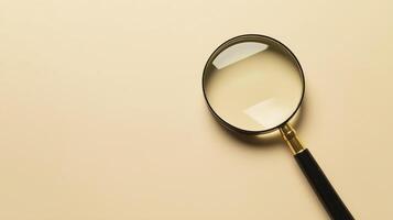 a magnifying glass on beige background, perfect for detailed examination photo